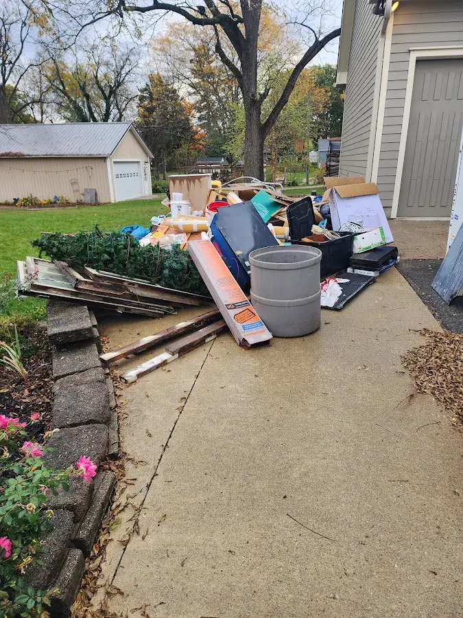 Dumpster being loaded with debris for Estate Cleanout Dumpster Rental in Dallas